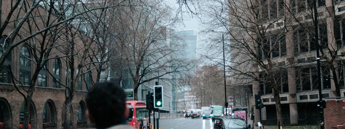 Person with a backpack on a wet city street