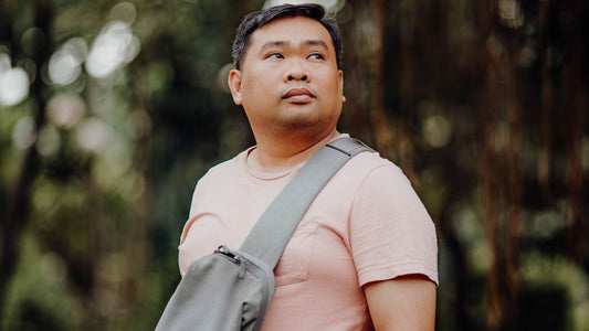 Man wearing a sling bag diagonally across his chest outdoors