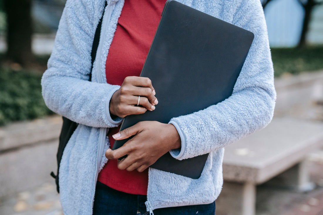 Woman sitting outdoors in a park working on a laptop