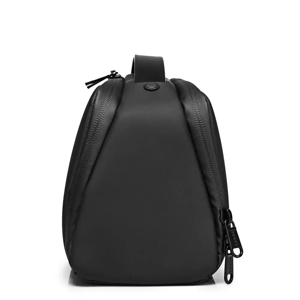 Side view of black BANGE BG-22196 toiletry bag with compact profile, zippered closure, and top hanging loop