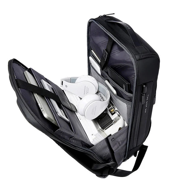 Interior view of the BANGE BG-7216 Plus anti-theft backpack, showing organized compartments with laptop, tablet, headphones, and accessories for business travel and daily commuting